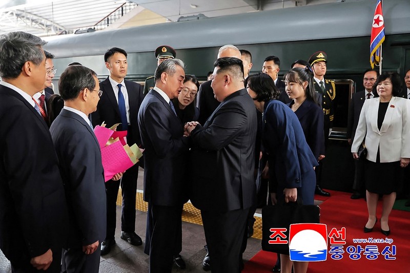 Pemimpin Korea Utara Kim Jong Un (tengah kanan) dan putrinya Kim Ju Ae (ketiga kanan) disambut oleh Sekretaris Pusat Partai Komunis Tiongkok, Cai Qi (tengah kiri), dan Menteri Luar Negeri Wang Yi (kedua dari kiri) setibanya di Stasiun Kereta Api Beijing. (Photo by KCNA VIA KNS / AFP)
