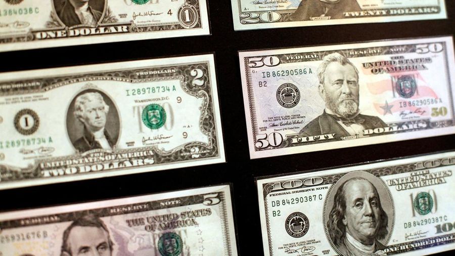 FILE PHOTO: United States dollar banknotes are seen at the Museum of American Finance in New York October 15, 2010. The U.S. dollar hit its lowest in more than eight months against the euro on Friday, while the Australian dollar surged above parity versus the greenback after Federal Reserve Chairman Ben Bernanke reinforced expectations of further monetary policy easing.    REUTERS/Shannon Stapleton/File Photo