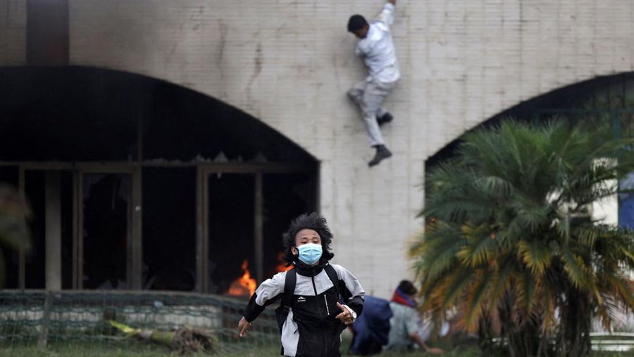 A demonstrators runs for cover as they are chased away by police jumps during a protest against corruption and the government’s decision to block several social media platforms, in Kathmandu, Nepal, September 8, 2025. REUTERS/Navesh Chitrakar