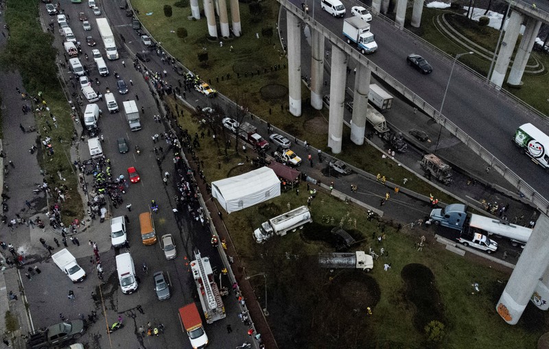 Seorang pria berjalan di samping sisa-sisa hangus sebuah trailer, salah satu kendaraan yang rusak dalam ledakan truk tangki gas di Jalan Ignacio Zaragoza, tempat beberapa orang mengalami luka bakar setelah truk tangki terbalik, di Mexico City, Meksiko, 10 September 2025. (REUTERS/Quetzalli Blanco)