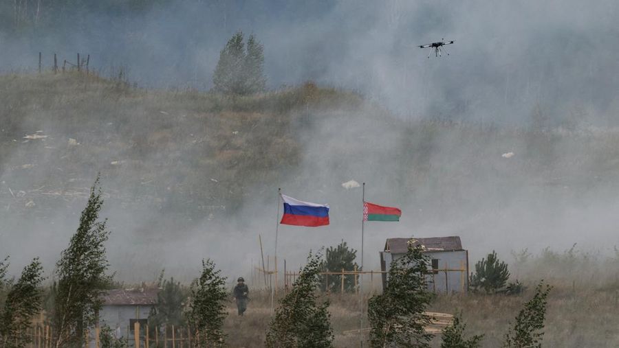 Russian and Belarusian flags fly at a training ground during the joint Russia-Belarus 