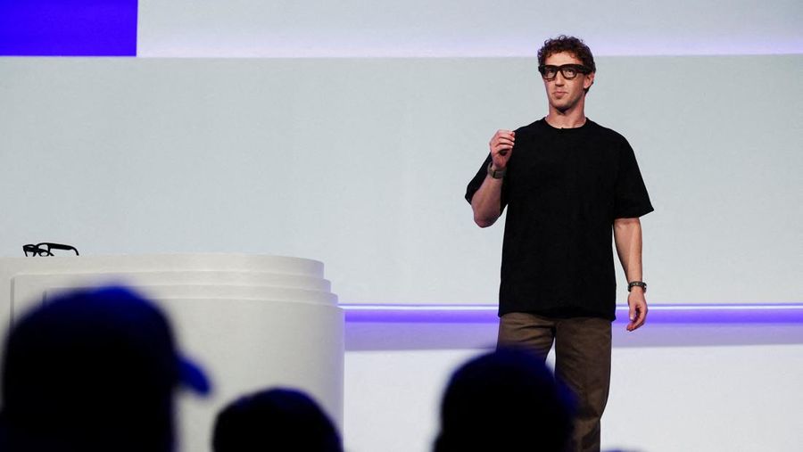 Meta CEO Mark Zuckerberg wears the Meta Ray-Ban Display glasses, as he delivers a speech presenting the new line of smart glasses, during the Meta Connect event at the company's headquarters in Menlo Park, California, U.S., September 17, 2025. REUTERS/Carlos Barria