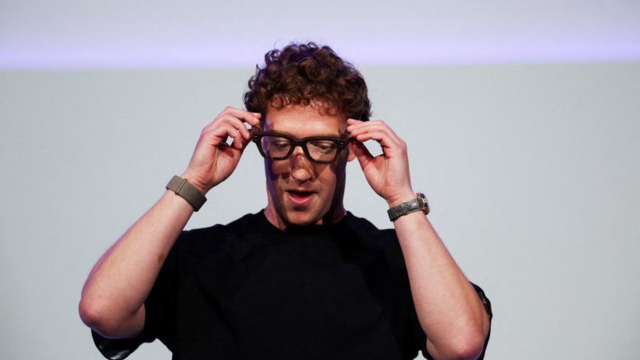 Meta CEO Mark Zuckerberg wears the Meta Ray-Ban Display glasses, as he delivers a speech presenting the new line of smart glasses, during the Meta Connect event at the company's headquarters in Menlo Park, California, U.S., September 17, 2025. REUTERS/Carlos Barria