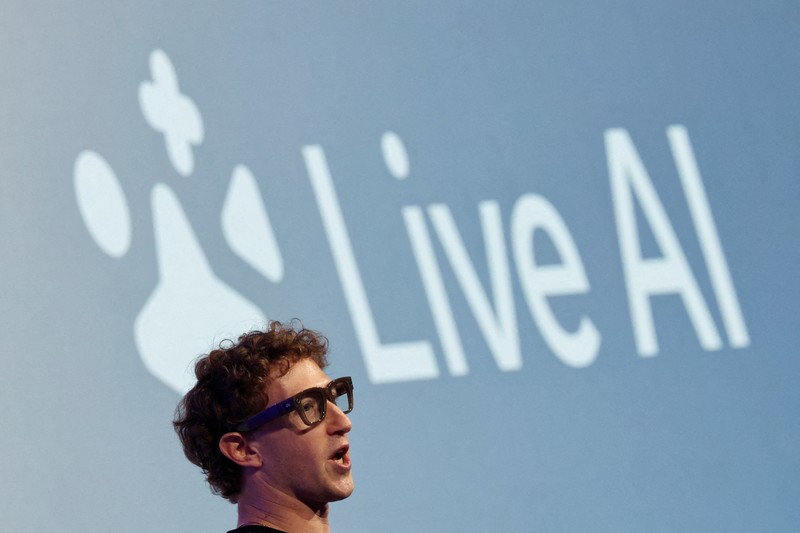 Meta CEO Mark Zuckerberg wears the Meta Ray-Ban Display glasses, as he delivers a speech presenting the new line of smart glasses, during the Meta Connect event at the company's headquarters in Menlo Park, California, U.S., September 17, 2025. REUTERS/Carlos Barria