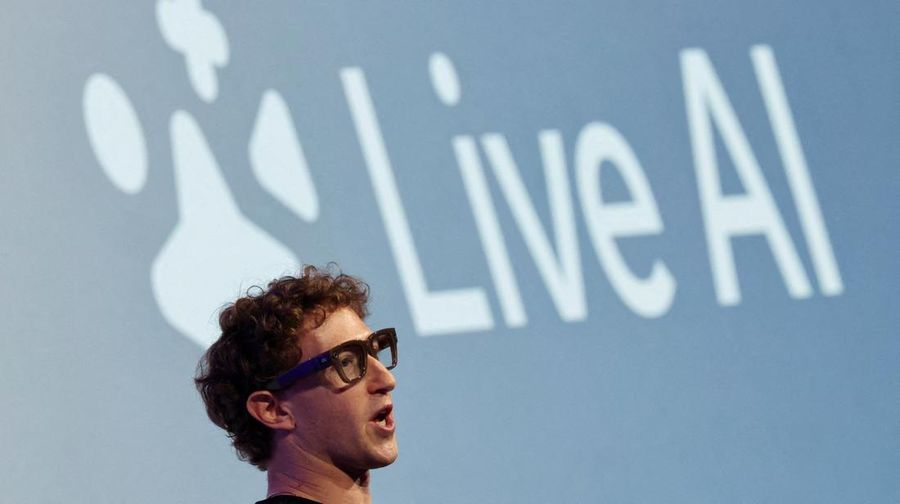 Meta CEO Mark Zuckerberg wears the Meta Ray-Ban Display glasses, as he delivers a speech presenting the new line of smart glasses, during the Meta Connect event at the company's headquarters in Menlo Park, California, U.S., September 17, 2025. REUTERS/Carlos Barria