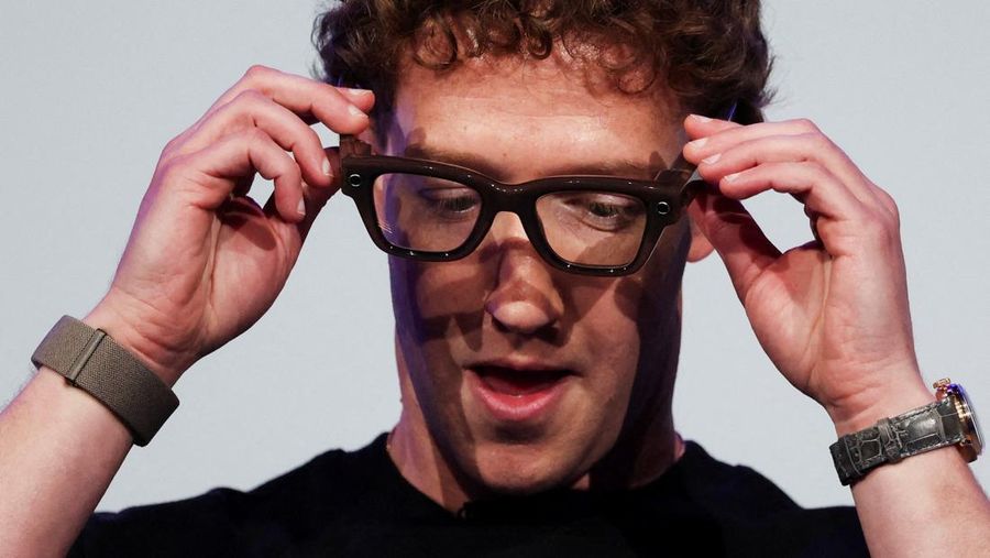 Meta CEO Mark Zuckerberg wears the Meta Ray-Ban Display glasses, as he delivers a speech presenting the new line of smart glasses, during the Meta Connect event at the company's headquarters in Menlo Park, California, U.S., September 17, 2025. REUTERS/Carlos Barria