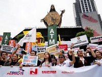 Filipino protesters raise placards during a protest denouncing corruption, in Quezon City, Metro Manila, Philippines, September 11, 2025. REUTERS/Lisa Marie David