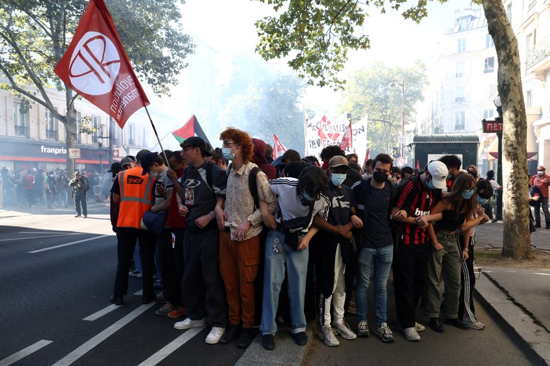 FRANCE-PROTEST/ French riot police stand amid tear gas during clashes at a demonstration in Paris as part of a day of nationwide strikes and protests against the government and cuts in the next budget, with supporters of the