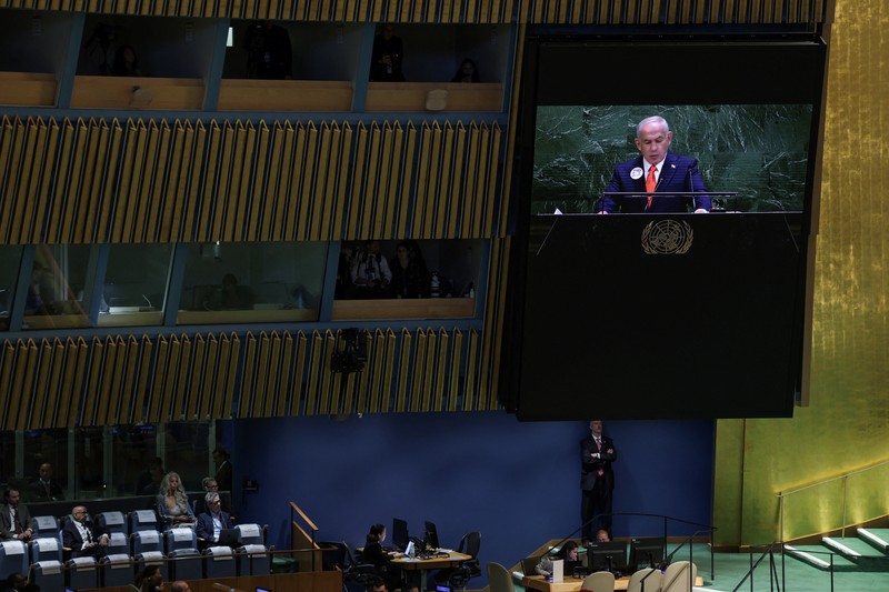 A screen displays Israeli Prime Minister Benjamin Netanyahu during his address, at the 80th United Nations General Assembly (UNGA) at U.N. headquarters in New York City, U.S., September 26, 2025. REUTERS/Jeenah Moon