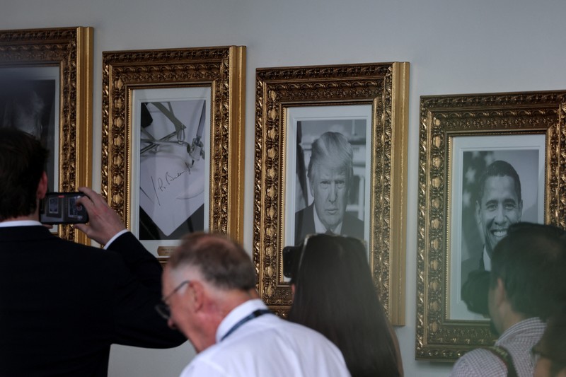 USA-TRUMP/ Journalists take pictures of an image of an autopen signing former U.S. President Joe Biden's signature which is displayed in place of a portrait of Biden next to portraits of U.S President Donald Trump at the