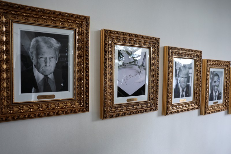 USA-TRUMP/ Journalists take pictures of an image of an autopen signing former U.S. President Joe Biden's signature which is displayed in place of a portrait of Biden next to portraits of U.S President Donald Trump at the
