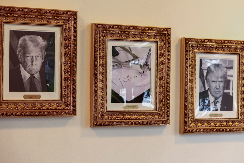 USA-TRUMP/ Journalists take pictures of an image of an autopen signing former U.S. President Joe Biden's signature which is displayed in place of a portrait of Biden next to portraits of U.S President Donald Trump at the