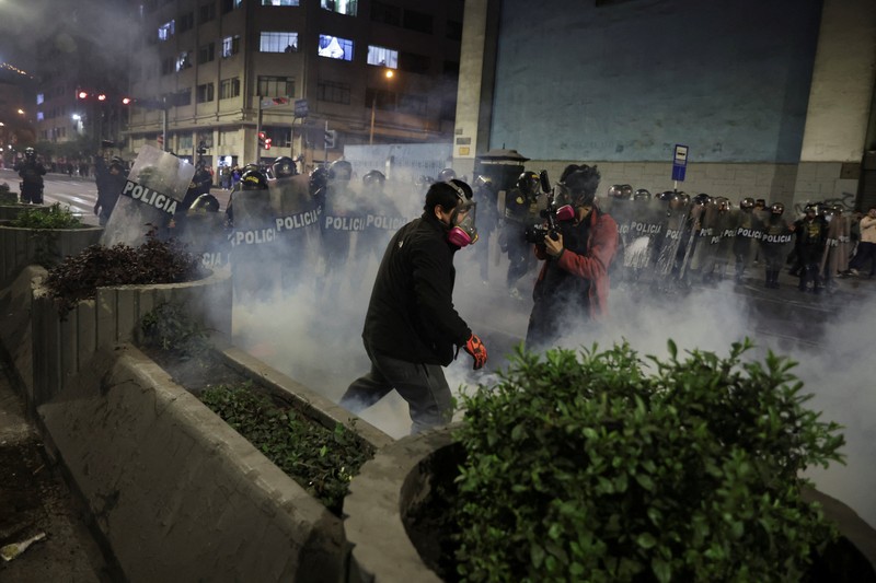 A Molotov cocktail falls on a police officer during a demonstration organised by a youth collective called 