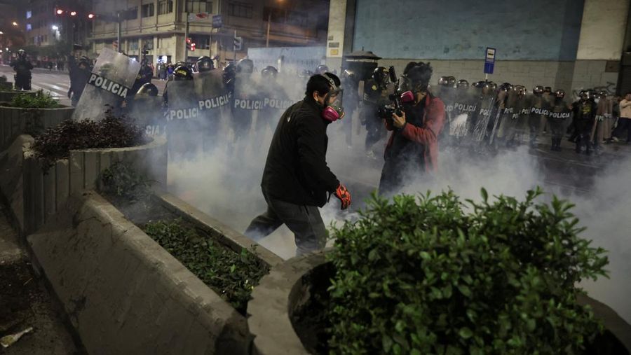 PERU-PROTEST/ A Molotov cocktail falls on a police officer during a demonstration organised by a youth collective called
