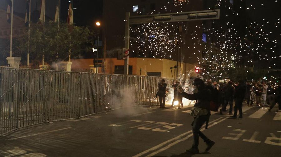 PERU-PROTEST/ A Molotov cocktail falls on a police officer during a demonstration organised by a youth collective called