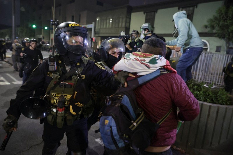 PERU-PROTEST/ A Molotov cocktail falls on a police officer during a demonstration organised by a youth collective called