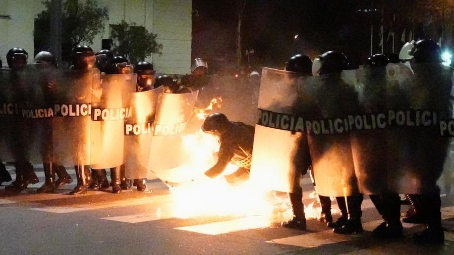 PERU-PROTEST/ A Molotov cocktail falls on a police officer during a demonstration organised by a youth collective called