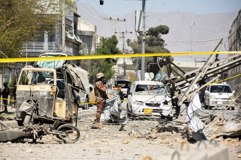 Seorang tentara paramiliter berdiri di tengah reruntuhan setelah ledakan bom di dekat markas Korps Perbatasan di Quetta, Pakistan, 30 September 2025. (REUTERS/Stringer)
