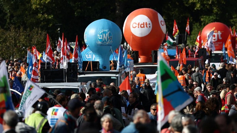 Para pengunjuk rasa memegang bendera serikat buruh selama demonstrasi di Nantes sebagai bagian dari hari pemogokan dan protes nasional terhadap pemerintah dan kemungkinan pemotongan penghematan, Prancis, 2 Oktober 2025. (REUTERS/Stephane Mahe)