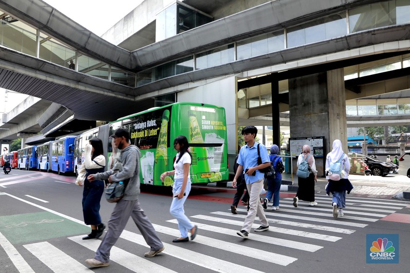 Sejumlah warga melintas di zebra cross halte Centrale Stichting Wederopbouw (CSW) di Kawasan Kebayoran Baru, Jakarta, Jumat, (3/10/2025). (CNBC Indonesia/Muhammad Sabki)