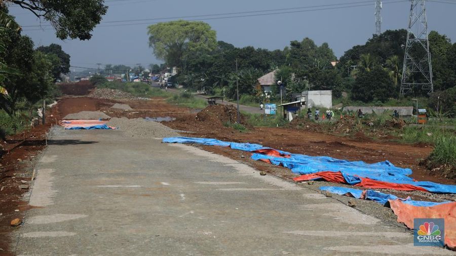 Sejumlah pekerja menyelesaikan progres pembangunan jalan Bojonggede-Kemang (Bomang) di Tajur Halang, Bogor, Senin (6/10/2025). (Srealm Indonesia/Tri Susilo)