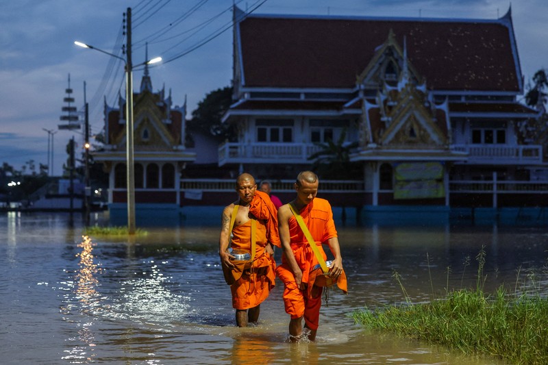 Patung-patung Buddha sebagian terendam di tepi sungai yang banjir akibat hujan deras dan luapan sungai, dengan Ayutthaya sebagai salah satu daerah yang paling parah terkena dampaknya, di distrik Bang Ban, provinsi Ayutthaya, Thailand, 8 Oktober 2025. REUTERS/Chalinee Thirasupa