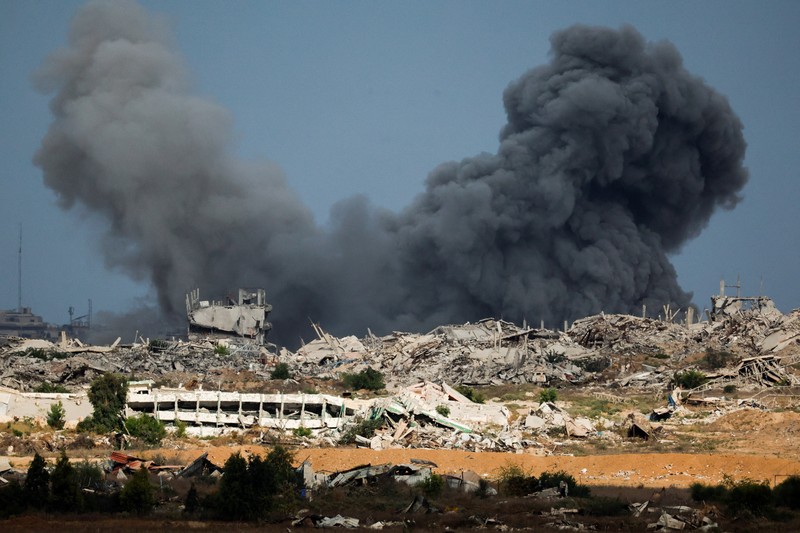 ISRAEL-PALESTINIANS/GAZA Asap mengepul dari Gaza, setelah Presiden AS Donald Trump mengumumkan bahwa Israel dan Hamas menyepakati fase pertama gencatan senjata di Gaza, seperti yang terlihat dari sisi perbatasan Israel dengan Gaza, 9 Oktober 2025. REUTERS/Ammar Awad