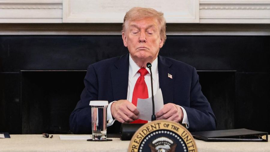 U.S. President Donald Trump holds a note that was handed to him by U.S. Secretary of State Marco Rubio during a roundtable on antifa, an anti-fascist movement Trump designated a domestic "terrorist organization" via executive order on September 22, at the White House in Washington, D.C., U.S., October 8, 2025. REUTERS/Evelyn Hockstein TPX IMAGES OF THE DAY