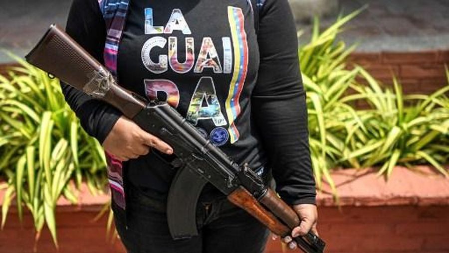 Members of the Bolivarian National Militia take part in military training in La Guaira, Venezuela on October 8, 2025. (Photo by Juan BARRETO / AFP)