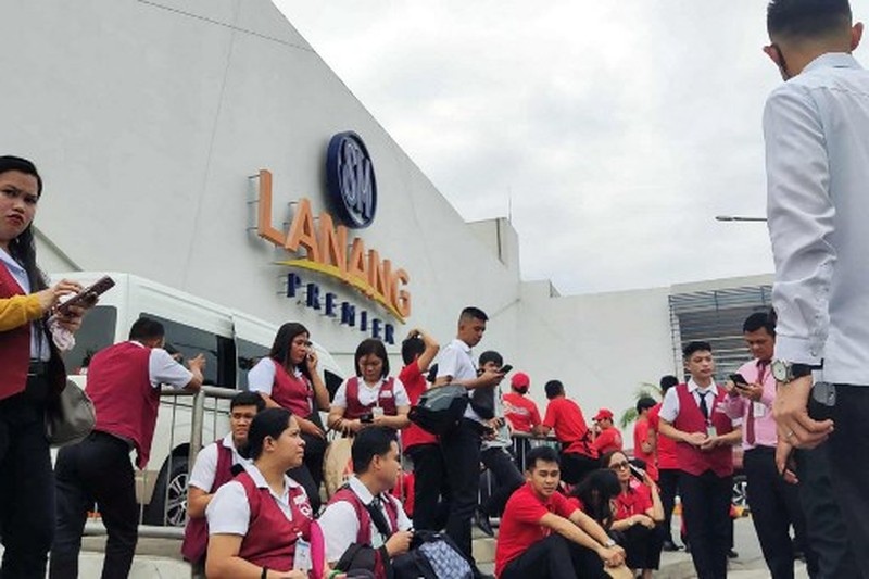 Para karyawan sebuah pusat perbelanjaan berkumpul di luar gedung di Kota Davao, di pulau selatan Mindanao, pada 10 Oktober 2025, setelah gempa berkekuatan 7,4 skala Richter melanda Filipina selatan.(Photo by Bobbie ALOTA / AFP)