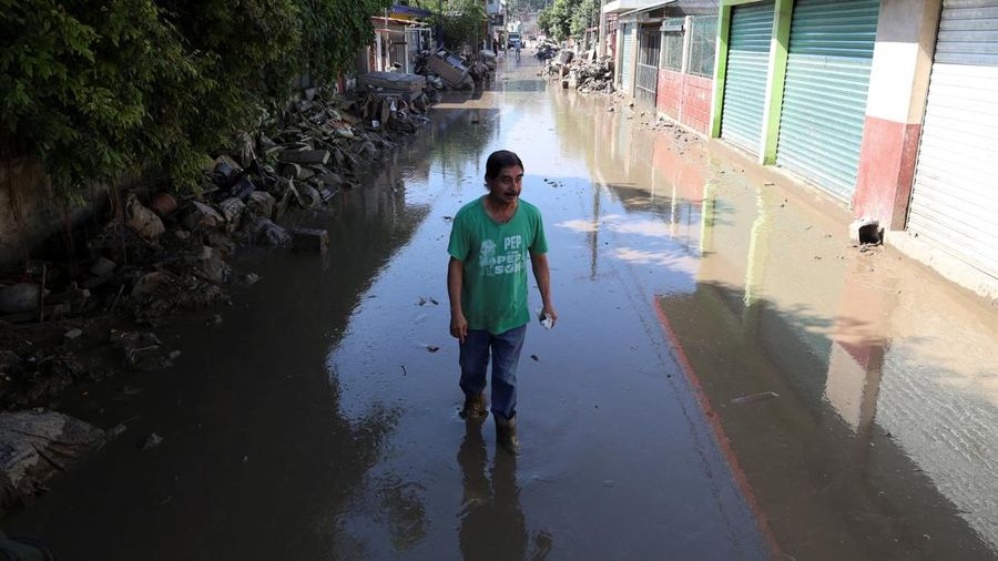 Tim relawan bergotong royong membantu warga yang terisolasi akibat banjir besar di Meksiko bagian tengah dan timur. Bencana ini telah menewaskan sedikitnya 64 orang, sementara 65 lainnya dilaporkan hilang, Jumat (17/10/2025). (REUTERS/Henry Romero)
