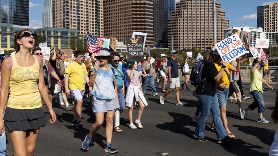 People march toward Auditorium Shores during a "No Kings" protest against U.S. President Donald Trump's policies, in Austin, Texas, U.S., October 18, 2025.  REUTERS/Nuri Vallbona