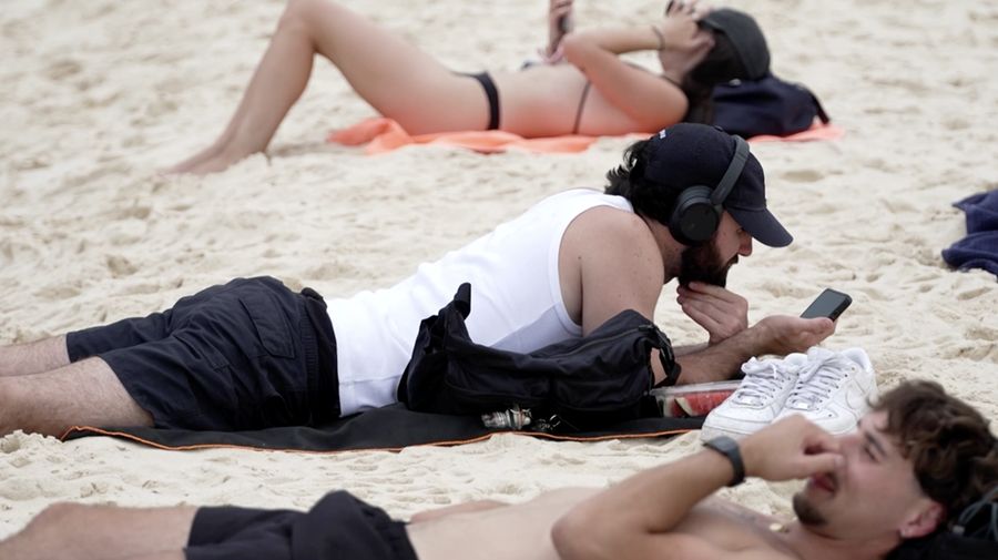Orang-orang berjemur di Pantai Bondi, karena suhu diperkirakan mencapai puncaknya 39 derajat Celsius, menurut Biro Meteorologi, di Sydney, Australia, 22 Oktober 2025. (REUTERS/Hollie Adams)