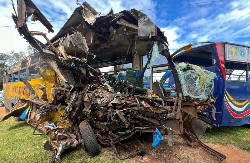 Puing-puing bus angkutan umum yang terlibat dalam tabrakan langsung diparkir di kantor polisi dekat lokasi kecelakaan maut di jalan raya Kampala-Gulu di distrik Kiryandongo, dekat Gulu, Uganda utara, 22 Oktober 2025. Puing-puing bus angkutan umum yang terlibat dalam tabrakan langsung diparkir di kantor polisi dekat lokasi kecelakaan maut di jalan raya Kampala-Gulu di distrik Kiryandongo, dekat Gulu, Uganda utara, 22 Oktober 2025. (REUTERS/Stringer)