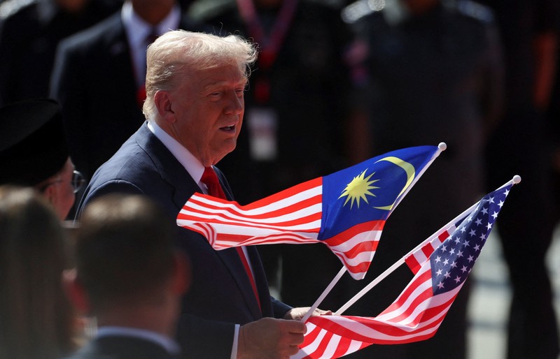 ASEAN-SUMMIT/TRUMP U.S. President Donald Trump joins the performers in a dance during a welcoming ceremony after arriving at Kuala Lumpur International Airport, to attend the 47th Association of Southeast Asian Nations (ASEAN) Summit, in Kuala Lumpur, Malaysia October 26, 2025. REUTERS/Hasnoor Hussain/Pool