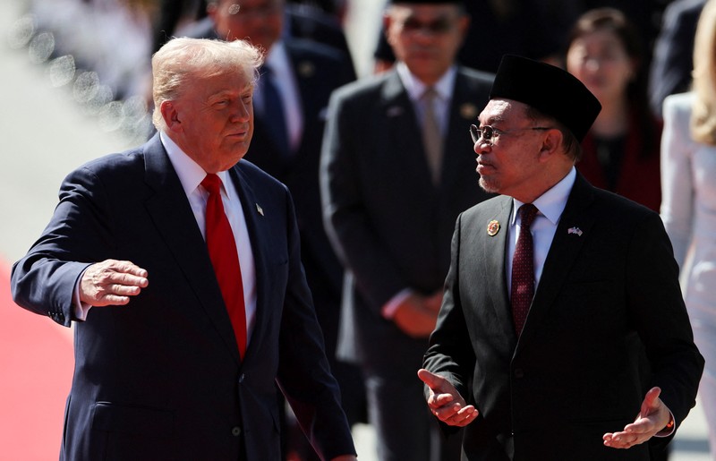 ASEAN-SUMMIT/TRUMP U.S. President Donald Trump joins the performers in a dance during a welcoming ceremony after arriving at Kuala Lumpur International Airport, to attend the 47th Association of Southeast Asian Nations (ASEAN) Summit, in Kuala Lumpur, Malaysia October 26, 2025. REUTERS/Hasnoor Hussain/Pool