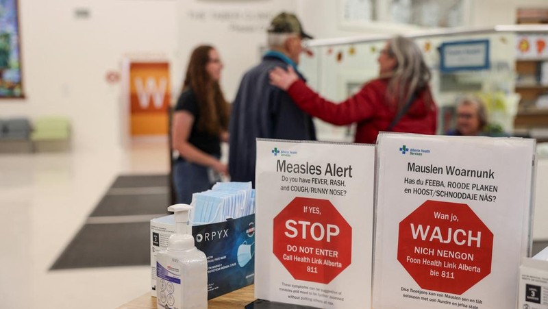 Orang-orang berdiri di dekat poster kesadaran kesehatan terkait wabah campak selama kampanye kesadaran kesehatan masyarakat, di Pusat Kesehatan Taber, di komunitas Mennonite yang sebagian besar berada di Taber, Alberta, Kanada, 27 Oktober 2025. Orang-orang berdiri di dekat poster kesadaran kesehatan terkait wabah campak selama kampanye kesadaran kesehatan masyarakat, di Pusat Kesehatan Taber, di komunitas Mennonite yang sebagian besar berada di Taber, Alberta, Kanada, 27 Oktober 2025. (REUTERS/Ahmed Zakot)