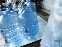 Pekerja mengisi air isi ulang galon di kawasan Depok, Jawa Barat, Selasa (28/10/2025). (CNBC Indonesia/Tri Susilo)