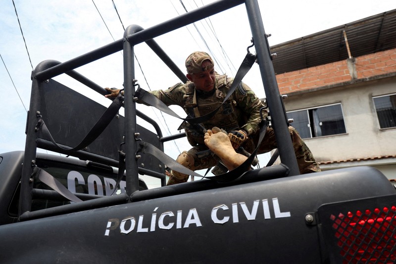 BRAZIL-VIOLENCE/ A man is detained by police officers during a police operation against drug trafficking at the favela do Penha, in Rio de Janeiro, Brazil October 28, 2025. REUTERS/Aline Massuca