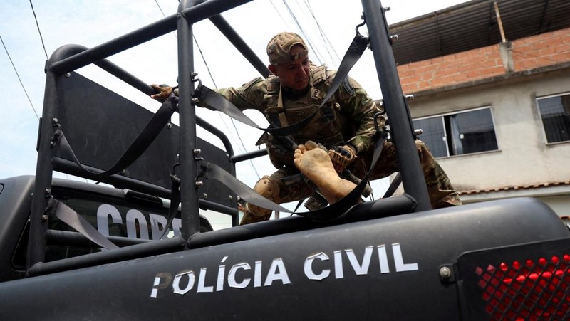 A man is detained by police officers during a police operation against drug trafficking at the favela do Penha, in Rio de Janeiro, Brazil October 28, 2025. REUTERS/Aline Massuca