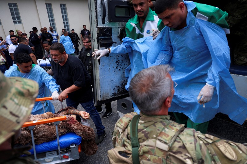 BRAZIL-VIOLENCE/ A man is detained by police officers during a police operation against drug trafficking at the favela do Penha, in Rio de Janeiro, Brazil October 28, 2025. REUTERS/Aline Massuca
