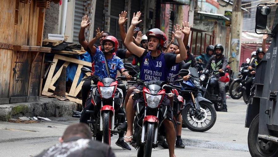 A man is detained by police officers during a police operation against drug trafficking at the favela do Penha, in Rio de Janeiro, Brazil October 28, 2025. REUTERS/Aline Massuca