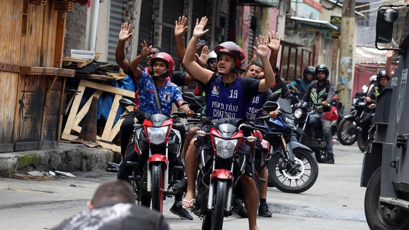 A man is detained by police officers during a police operation against drug trafficking at the favela do Penha, in Rio de Janeiro, Brazil October 28, 2025. REUTERS/Aline Massuca