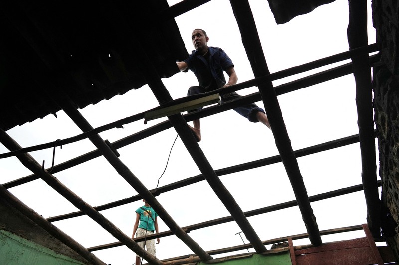 STORM-MELISSA/CUBA A man herds cattle along the coastline ahead of Hurricane Melissa's landfall, in Santiago de Cuba, Cuba, October 28, 2025. REUTERS/Norlys Perez     TPX IMAGES OF THE DAY