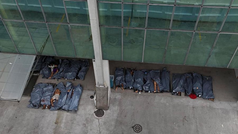 BRAZIL-VIOLENCE/ SENSITIVE MATERIAL. THIS IMAGE MAY OFFEND OR DISTURB A mourner kisses a covered body, the day after a deadly police operation against drug trafficking at the favela do Penha, in Rio de Janeiro, Brazil, October 29, 2025. REUTERS/Ricardo Moraes     TPX IMAGES OF THE DAY