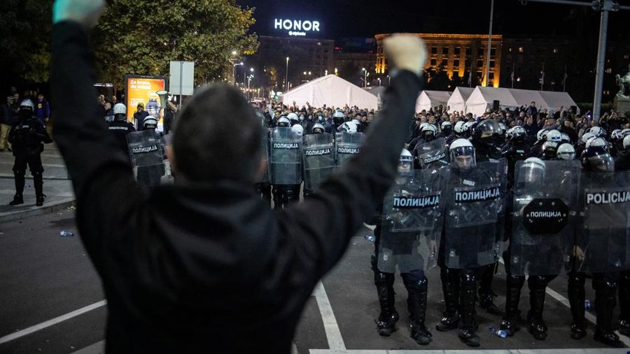 Seorang demonstran antipemerintah memberi isyarat di depan petugas penegak hukum dengan perlengkapan anti huru hara di dekat parlemen di Beograd, Serbia, 2 November 2025. (REUTERS/Marko Djurica)
