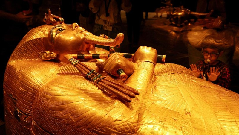 Pengunjung melihat peti mati emas Firaun Mesir kuno Tutankhamun pada hari pertama pengunjung setelah pembukaan resmi Museum Agung Mesir (GEM), dekat kompleks piramida Giza, di Giza, Mesir, 4 November 2025. (REUTERS/Mohamed Abd El Ghany)