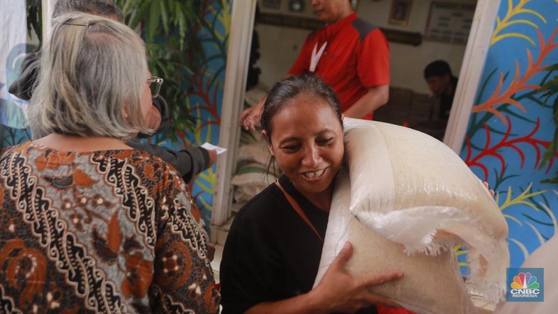 Warga mengantre untuk mengambil bantuan pangan gratis di Balai RW 03 Kelurahan Menteng, Jakarta, Rabu (12/11/2025). (CNBC Indonesia/Muhammad Sabki)