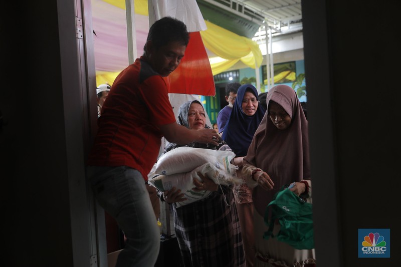 Warga mengantre untuk mengambil bantuan pangan gratis di Balai RW 03 Kelurahan Menteng, Jakarta, Rabu (12/11/2025). (CNBC Indonesia/Muhammad Sabki)