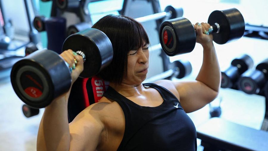 Hitomi Harigae, 38 tahun, manajer Muscle Girls, sebuah bar bertema kebugaran, memamerkan otot-ototnya saat pertunjukan tari di Tokyo, Jepang, 25 Juli 2025. 